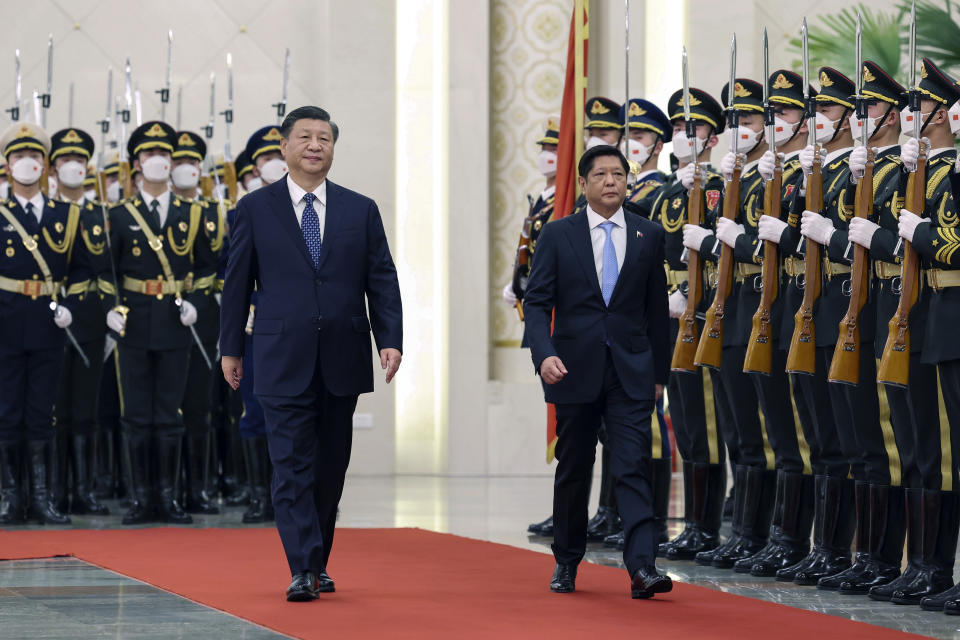 In this photo released by Xinhua News Agency, Visiting Philippine President Ferdinand Marcos Jr., right, and Chinese President Xi Jinping review an honor guard during a welcome ceremony at the Great Hall of the People in Beijing, Wednesday, Jan. 4, 2023. Philippine President Ferdinand Marcos Jr. is pushing for closer economic ties on a visit to China that seeks to sidestep territorial disputes in the South China Sea. (Yao Dawei/Xinhua via AP)