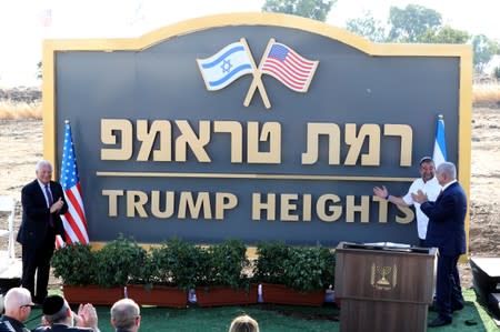Israeli Prime Minister Benjamin Netanyahu and U.S. Ambassador to Israel David Friedman attend a ceremony to unveil a sign for a new community named after U.S. President Donald Trump, in the Israeli-occupied Golan Heights