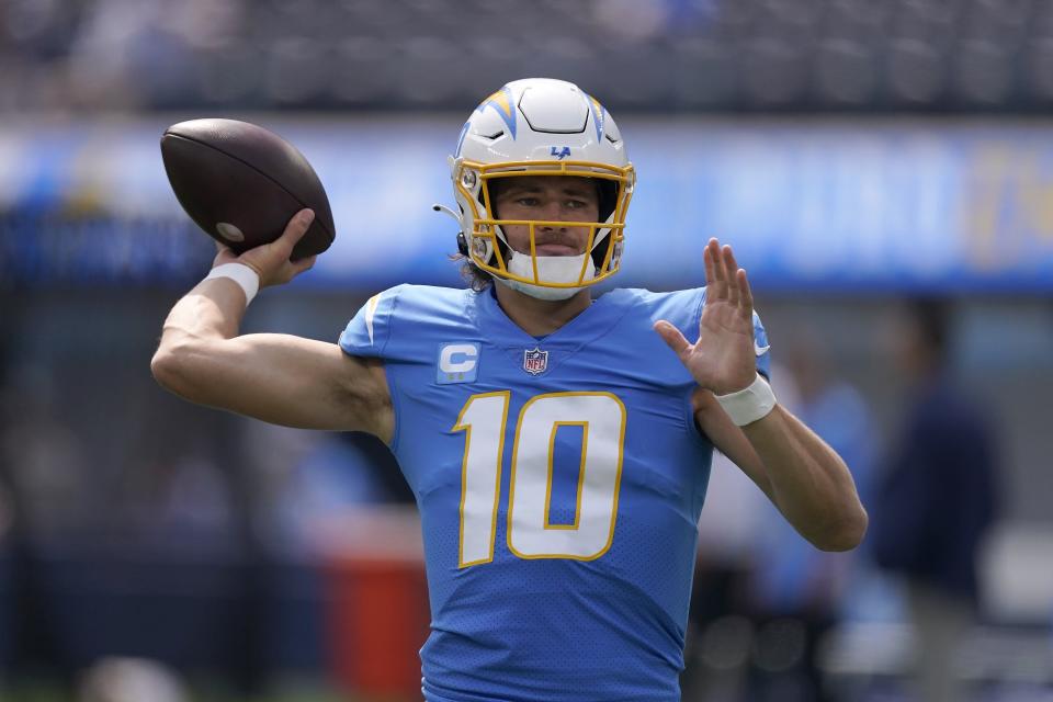 Los Angeles Chargers quarterback Justin Herbert (10) warms up before an NFL football game against the Jacksonville Jaguars in Inglewood, Calif., Sunday, Sept. 25, 2022. (AP Photo/Mark J. Terrill)