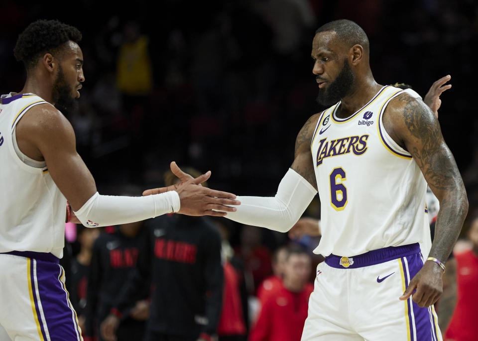 Los Angeles Lakers forward LeBron James, right, and forward Troy Brown Jr. celebrate after defeating the Portland Trail Blazers in an NBA basketball game in Portland, Ore., Sunday, Jan. 22, 2023. (AP Photo/Craig Mitchelldyer)