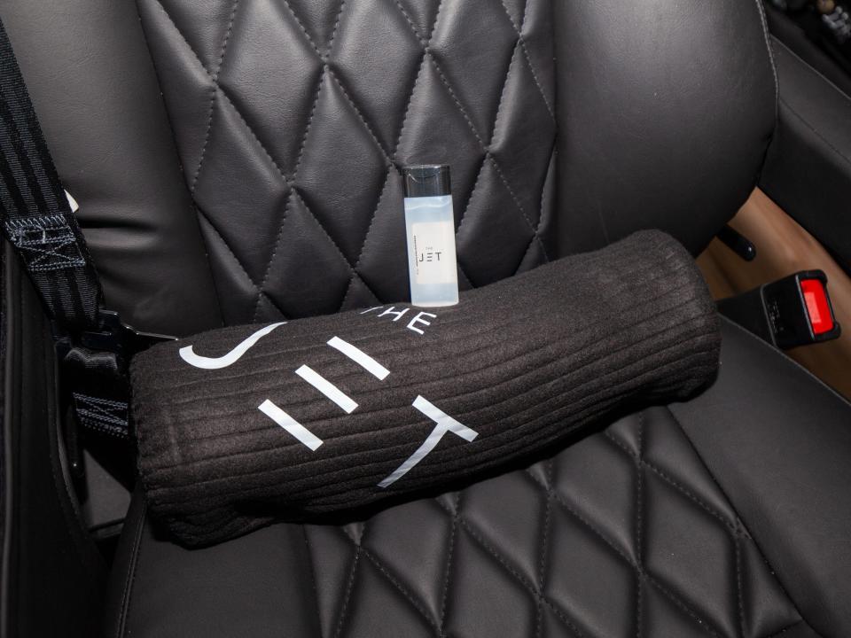 blanket and hand sanitizer on one of the seats