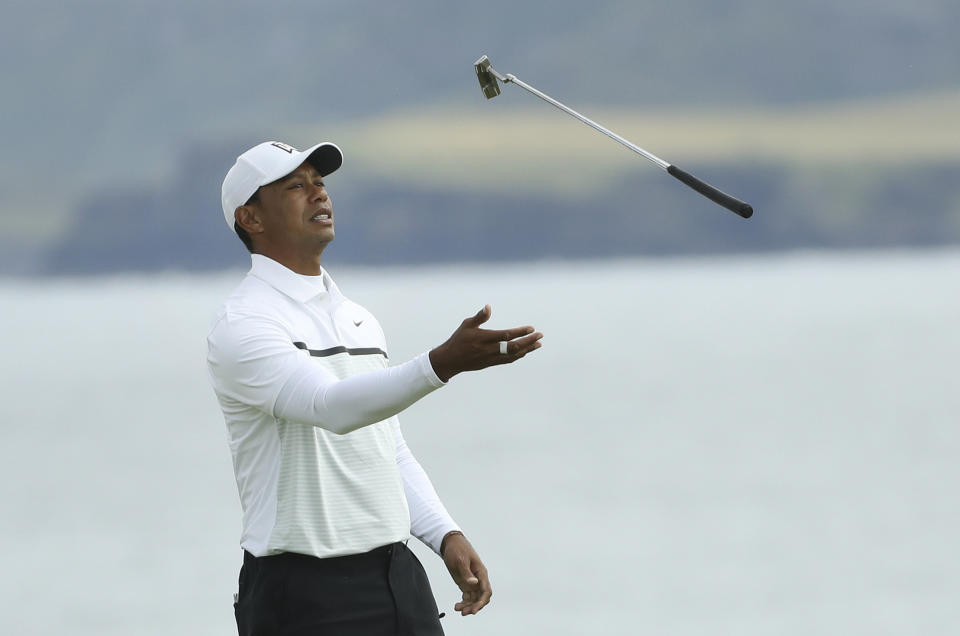 Tiger Woods of the United States throws his club in the air con the 5th green during the second round of the British Open Golf Championships at Royal Portrush in Northern Ireland, Friday, July 19, 2019.(AP Photo/Peter Morrison)