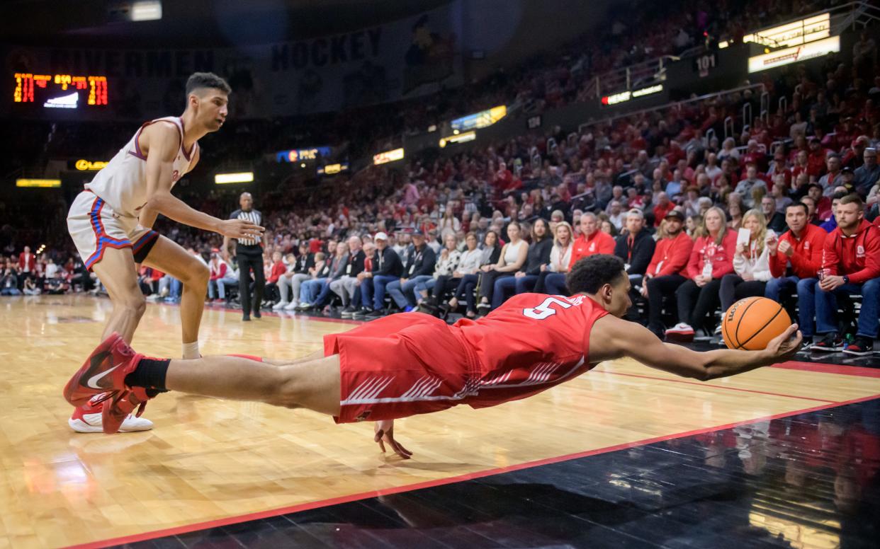 ISU's Jordan Davis dives for a ball headed out of bounds as Bradley's Malevy Leons looks on in the second half of their Missouri Valley Conference basketball game Saturday, Feb. 24, 2024 at Carver Arena in Peoria.