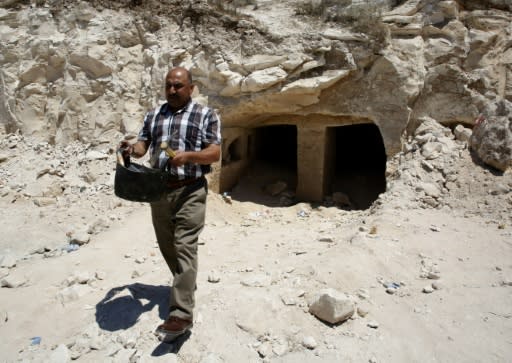 Taleb Jubran, director of the department of tourism and antiquities in Hebron, works at a newly discovered Roman-era burial site in the West Bank on August 16, 2018