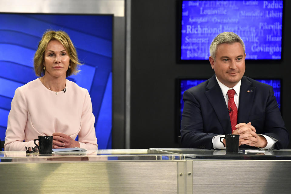 Kentucky gubernatorial candidate Kelly Craft, left, and Kentucky Agricultural Commissioner Ryan Quarles get ready for the start of the Kentucky Gubernatorial GOP Primary Debate in Lexington, Ky., Monday, May 1, 2023. (AP Photo/Timothy D. Easley)