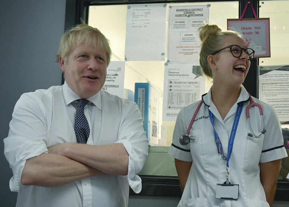 Britain's Prime Minister Boris Johnson talks with staff at King's Mill Hospital in Mansfield, northern England, Friday Nov. 8, 2019, during a general election campaign visit. Britain goes to the polls on Dec. 12 to vote in a pre-Christmas general election. (Daniel Leal-Olivas/Pool via AP)