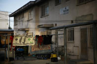 Laundry hangs on a clothesline outside an apartment building at the Jordan Downs housing project in the Watts neighborhood of Los Angeles, Monday, June 15, 2020. (AP Photo/Jae C. Hong)