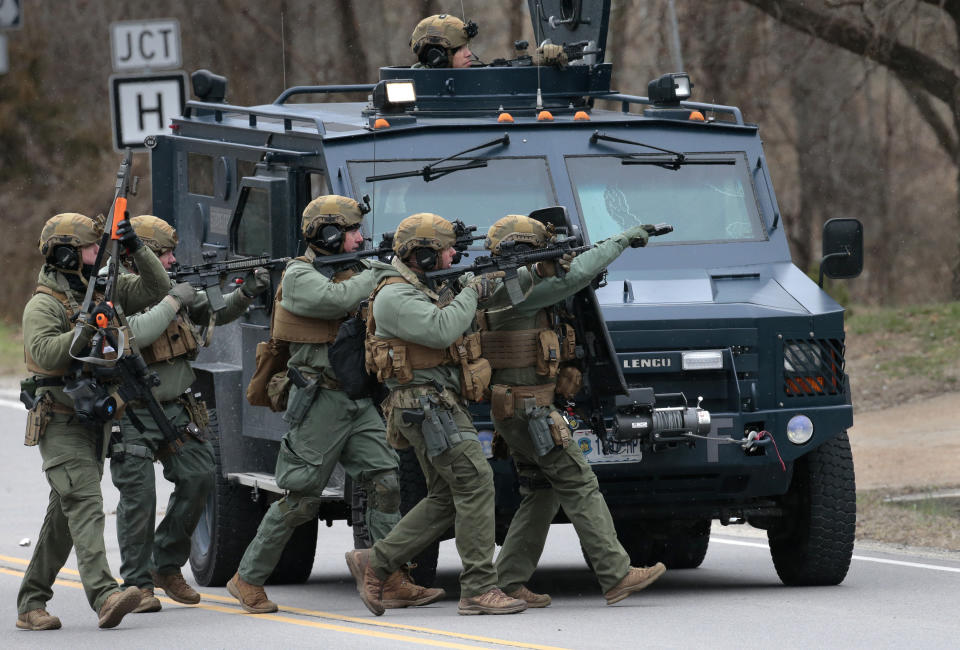 A tactical unit from the Missouri Highway Patrol moves to enter a home where a man was believed to be hiding after being accused of shooting two Hermann police officers Sunday night, on Monday, March 13, 2023. The tactical officers moved debris from the front door and retreated. The shooting about 9:30 p.m. Sunday killed Detective Sgt. Mason Griffith of the Hermann Police Department. (Robert Cohen/St. Louis Post-Dispatch via AP)