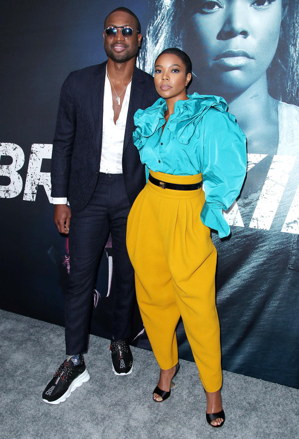 Superior style! The pair showed off their flair for fashion at the Breaking In film premiere, wearing equally fabulous and unique outfits. The L.A.'s Finest actress donned high waisted yellow pants and a voluminous turquoise top. Wade showed off his stylish side in a slim fit suit which he teamed with sunglasses and sneakers.