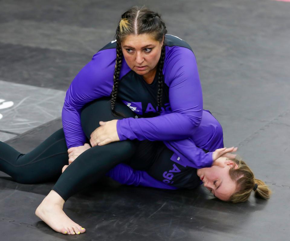 Jenn Kozlowski,, top eyes her next move while working Jiu Jitsu with Maggie Wickenhauser, Monday, November 13, 2023, in Sheboygan, Wis.