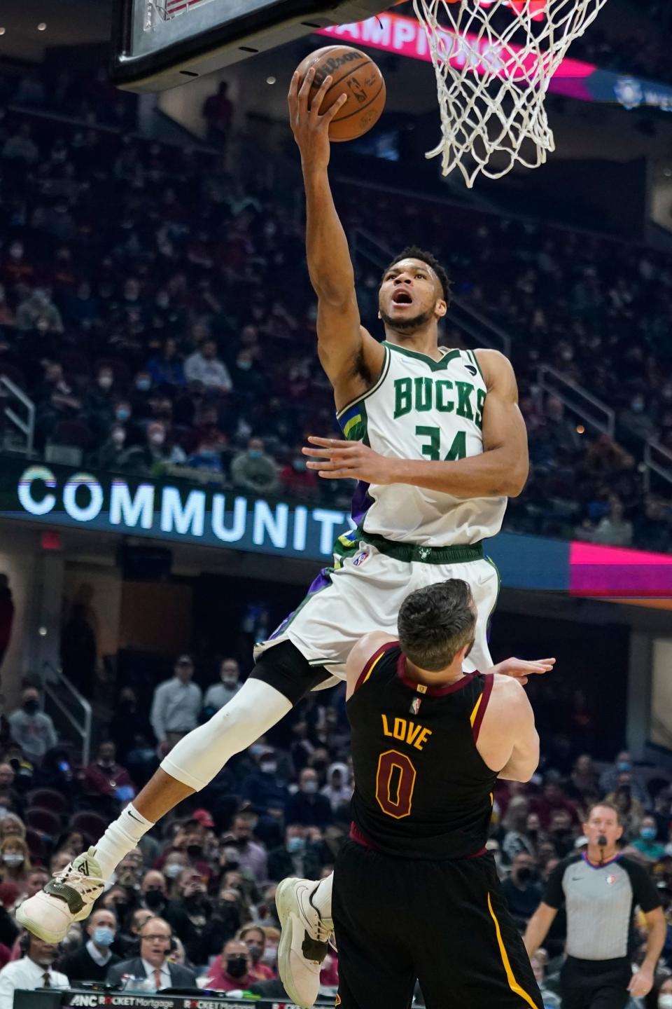 Milwaukee Bucks forward Giannis Antetokounmpo (34) drives to the basket over Cavaliers forward Kevin Love (0) in the first half of the Cavs' 115-99 win Wednesday night in Cleveland. [Tony Dejak/Associated Press]