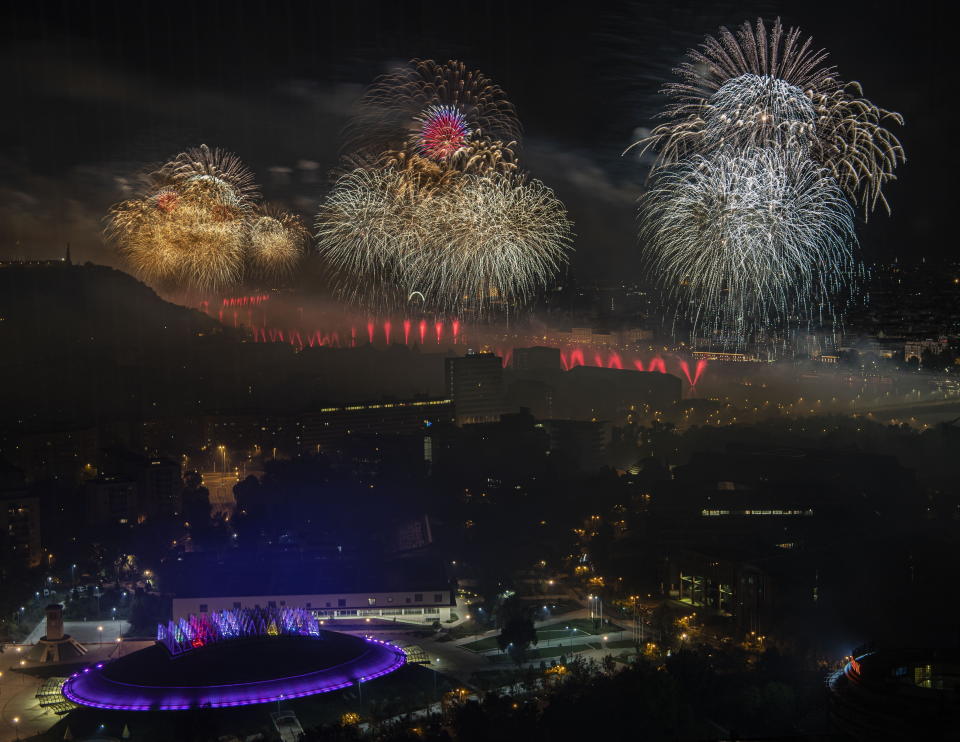 Fireworks explode above the River Danube as part of the postponed celebrations of the country's major national holiday in downtown Budapest, Hungary, Saturday, Aug. 27, 2022. Each year on 20th August Hungarians commemorate the foundation of their state and its founder King St Stephen. (Szilard Koszticsak/MTI via AP)
