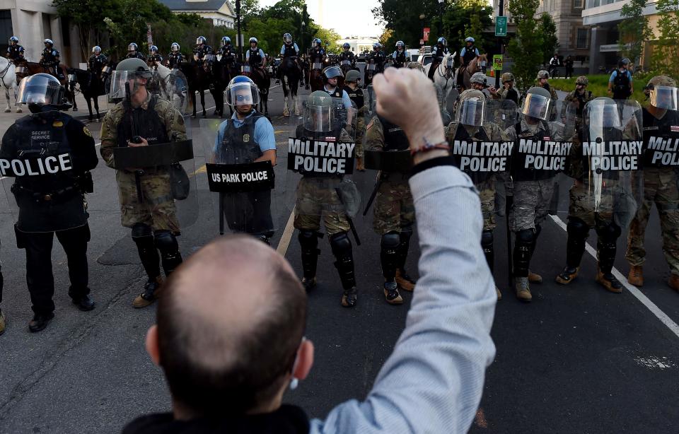Military police members face off with demonstrators outside the White House to protest the death of George Floyd, who died in police custody in Minneapolis