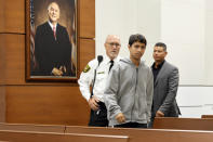 Former Marjory Stoneman Douglas High School student Anthony Borges, who was injured in the 2018 shootings, enters the courtroom with his father, Royer Borges, to testify during the trial of former Marjory Stoneman Douglas High School School Resource Officer Scot Peterson, Thursday, June 8, 2023, at the Broward County Courthouse in Fort Lauderdale, Fla. Peterson is charged with child neglect and other charges for failing to stop the Parkland school massacre five years ago. (Amy Beth Bennett/South Florida Sun-Sentinel via AP, Pool)