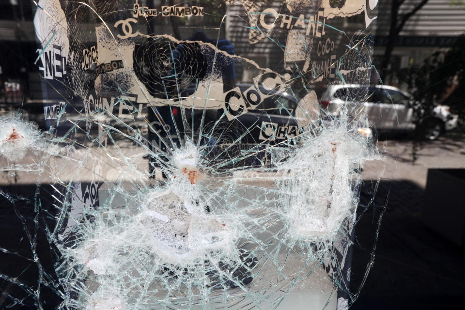 A window at a Chanel store shattered during protests Saturday is seen Sunday, May 31, 2020, in the SoHo neighborhood of New York. (AP Photo/Kathy Willens)