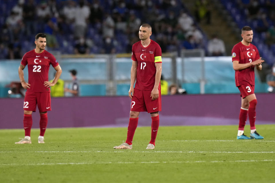 From left, Turkey's Kaan Ayhan, Burak Yilmaz and Merih Demiral react after Italy's Lorenzo Insigne scored his side's third goal, during the Euro 2020, soccer championship group A match between Italy and Turkey, at the Rome Olympic stadium, Friday, June 11, 2021. (AP Photo/Alessandra Tarantino, Pool)