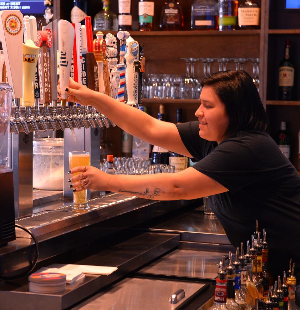 Rigsby's Smoked Burgers Wings & Grill at 176 N. Liberty Street in Spartanburg, Wednesday, December 8, 2021. The new restaurant has opened in the former Hub City Co-op building. Bartender Miranda Jimenez pours a beer.