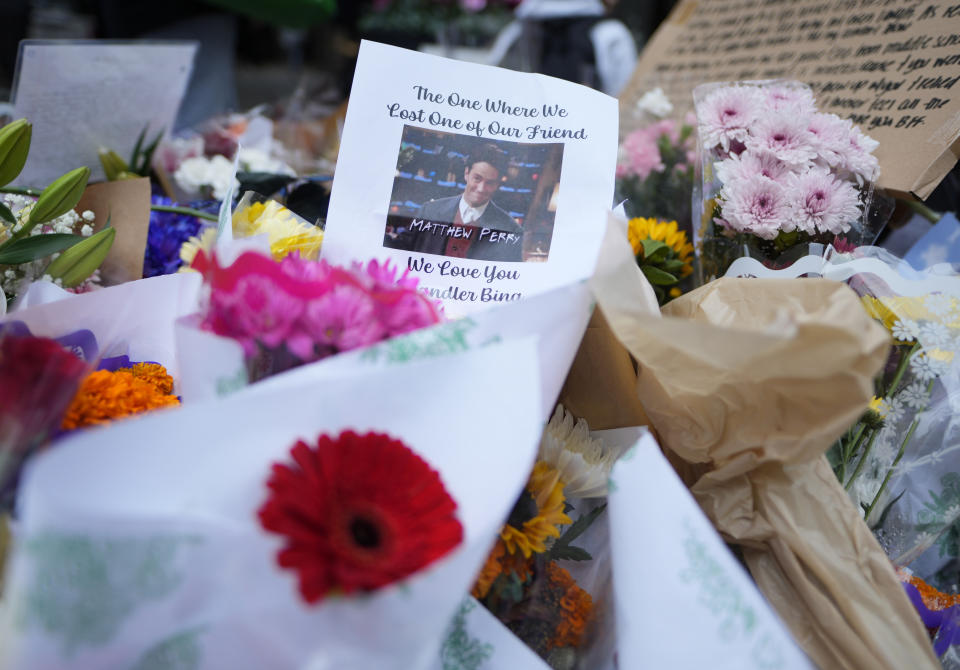 A makeshift memorial for Matthew Perry is seen outside the building shown in exterior shots of the television show "Friends" on Monday, Oct. 30, 2023, in New York. Perry, who played Chandler Bing on NBC's "Friends" for 10 seasons, was found dead at his Los Angeles home on Saturday. He was 54. (Photo by Charles Sykes/Invision/AP)