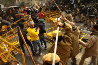 NEW DELHI, INDIA - JANUARY 26: Delhi Police personnel lathicharge protesters in the farmers march to Delhi in protest against farm reform laws, in New Delhi on India January 26, 2021, The thousands of farmers drove a convoy of tractors into the Indian capital as the nation celebrated Republic Day on Tuesday in the backdrop of agricultural protests that have grown into a rebellion and rattled the government. (Photo by Imtiyaz Khan/Anadolu Agency via Getty Images)