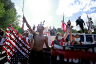 Native American protesters form a roadblock on the road leading to Mount Rushmore ahead of President Donald Trump's visit to the memorial on Friday, July 3, 2020, in Keystone, S.D. (AP Photo/Stephen Groves)