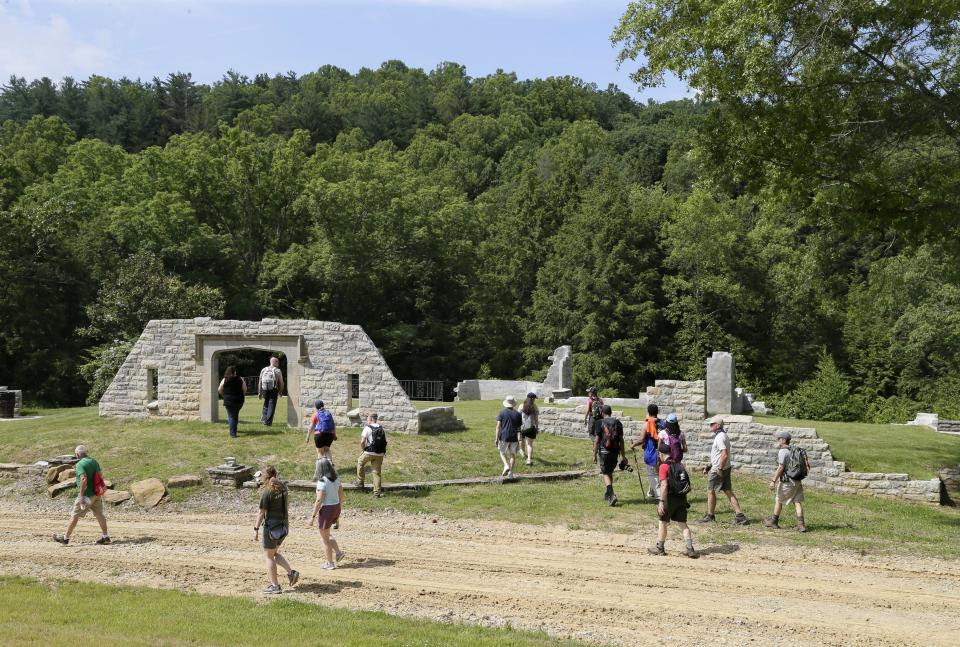 Members of the Friends of the MetroParks explore the remains of the Benua House, a 4,700-square-foot structure on previously private land, during a tour at Clear Creek Metro Park in June 2021.