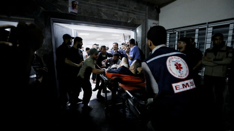An injured person is assisted by medical personnel at the Al-Shifa Hospital after a blast at Al-Ahli Baptist Hospital in Gaza City on Tuesday, October 17. - Mohammed Al-Masri/Reuters