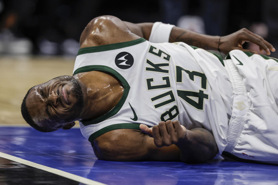 Milwaukee Bucks forward Thanasis Antetokounmpo grimaces on floor during during the second half of the team's NBA basketball game against the Orlando Magic, Saturday, Nov. 11, 2023, in Orlando, Fla. (AP Photo/Kevin Kolczynski)