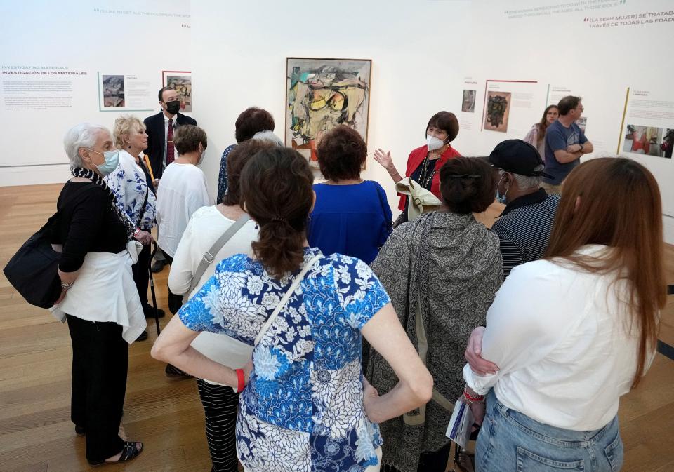 The public views the "Woman-Ochre," an oil painting by Willem de Kooning, at the Getty Museum in Los Angeles. The painting was stolen in 1985, recovered by antique dealers in 2017 and then restored by Getty conservators.