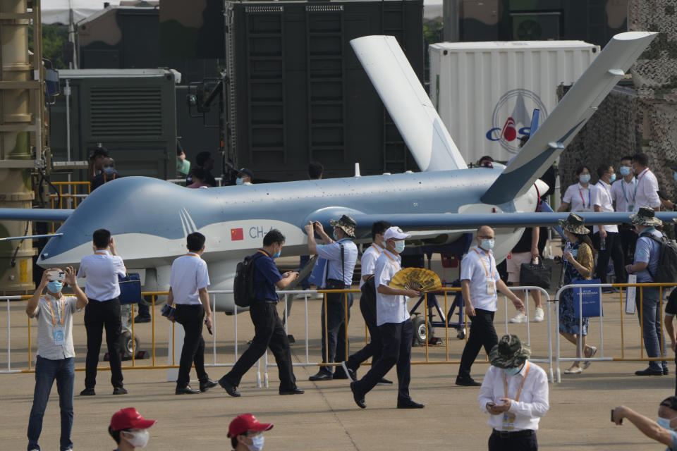 Visitors walk past a Chinese made CH-4 drone during the 13th China International Aviation and Aerospace Exhibition, also known as Airshow China 2021 on Tuesday, Sept. 28, 2021 in Zhuhai in southern China's Guangdong province. (AP Photo/Ng Han Guan)