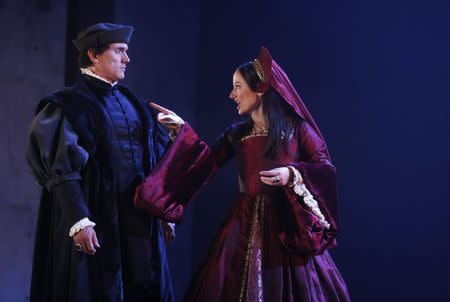 Actors Ben Miles (as Thomas Cromwell) and Lydia Leonard (as Anne Boleyn) perform in an adaptation of Hilary Mantel's books "Wolf Hall" and "Bring Up the Bodies" during a photocall at the Aldwych Theatre in London May 15, 2014. REUTERS/Luke MacGregor
