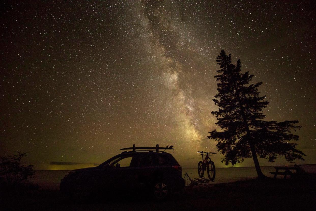 A visitor’s car and bike are silhouetted against the night sky at the Upper Peninsula’s Keweenaw Dark Sky Park. Creating a dark sky park has been discussed in St. Joseph County's parks and recreation planning.