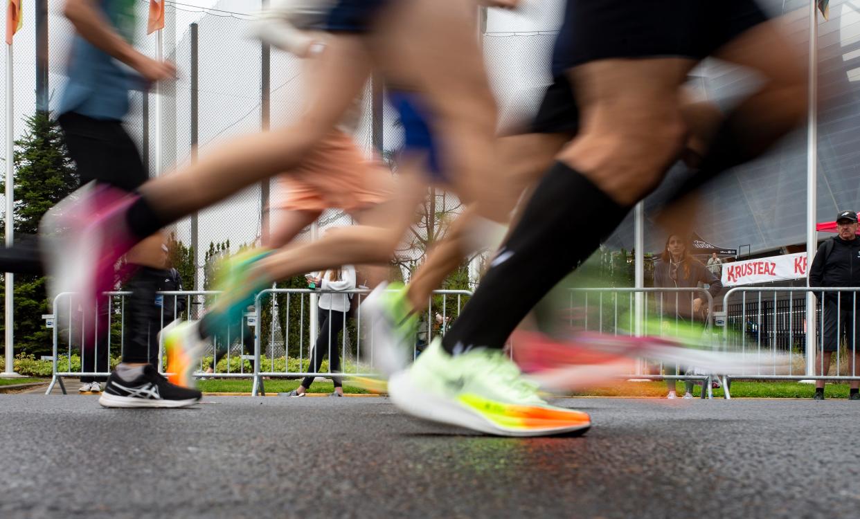 Runners pass Hayward Field near the ninth mile of the Eugene Marathon Sunday, April 30, 2023, in Eugene, Ore. 