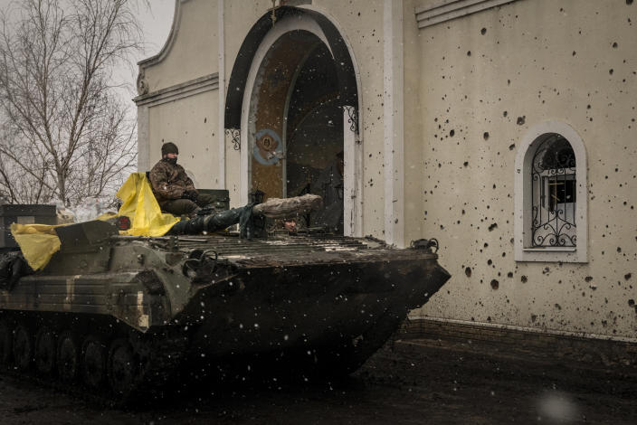 A Ukrainian armored vehicle passes by a damaged church,  in the Donetsk region of Ukraine on Thursday, Jan. 5, 2023.  (Nicole Tung/The New York Times)