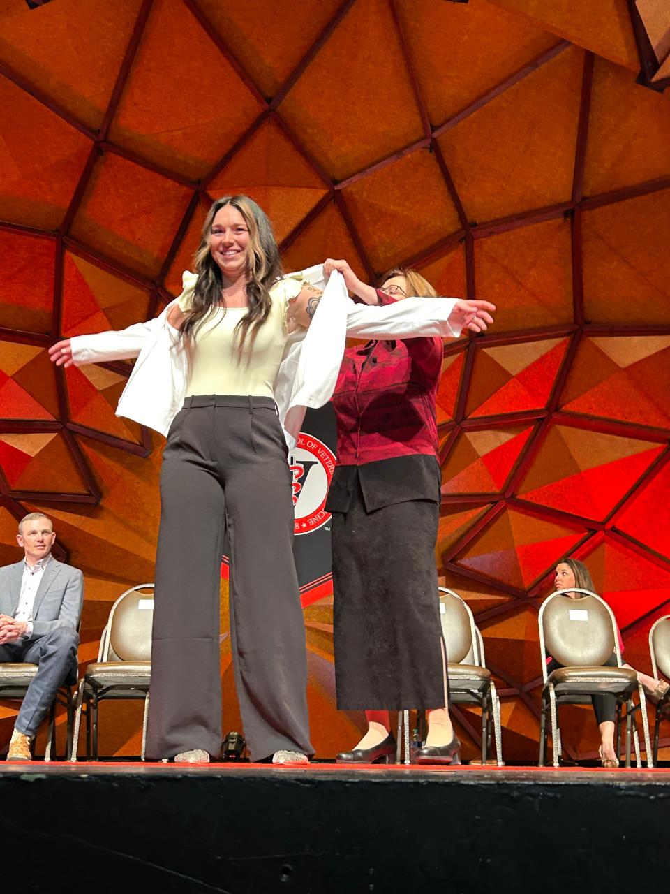 Kenzie Salzman was "coated" by Dr. Nancy Zimmerman Sunday during the Texas Tech vet school's first white coat ceremony at the Globe-News Center. Grads will go to clinicals in the next step of becoming veterinarians.