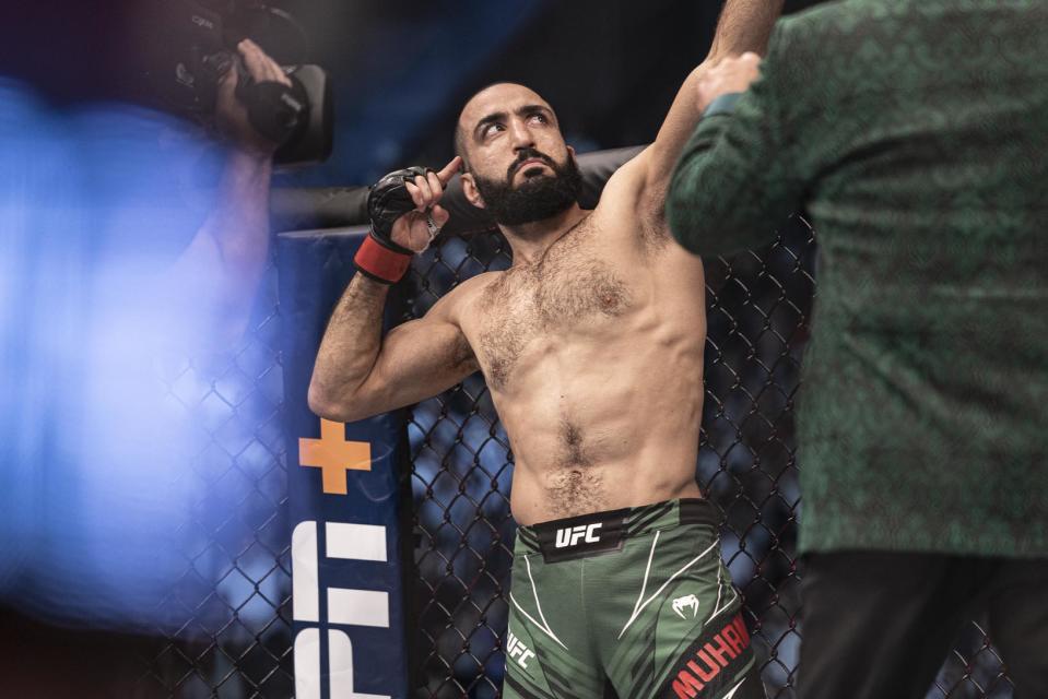 Oct 22, 2022; Abu Dhabi, UAE; Belal Muhammad (red gloves) is introduced before his fight against Sean Brady (blue gloves) during UFC 280 at Etihad Arena. Mandatory Credit: Craig Kidwell-USA TODAY Sports