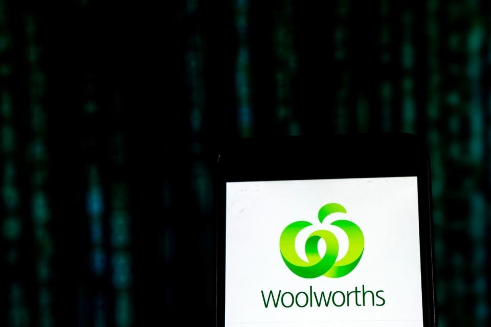 Woolworths logo on mobile phone with tech backdrop