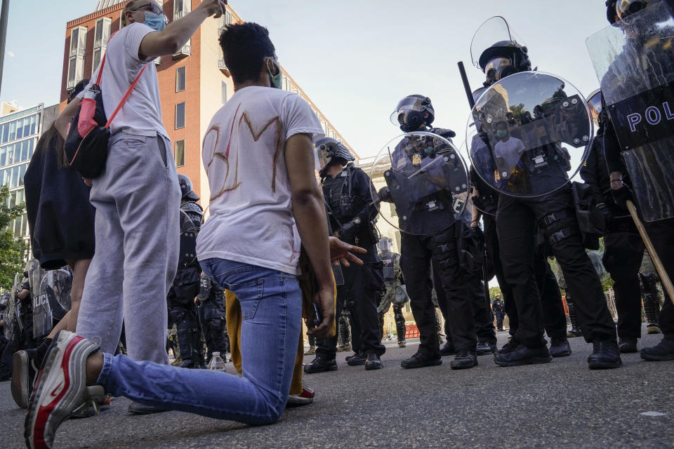 Demonstrators confront law enforcement.