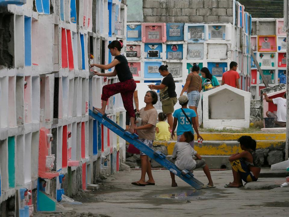 Relatives spruce up the crypts of their departed loved ones on the eve of the observance of All Saint's Day among Roman Catholics Saturday, Oct.31, 2015 at suburban Paranaque city south of Manila, Philippines. Roman Catholics and other Christians all over the world pay their respects to the dead every Nov.1 with prayers and visits to cemeteries and memorial parks.