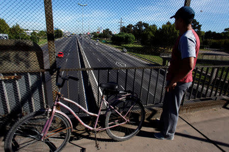 A man looks from a bridge at Panamericana highway which is almost empty due to a blockade by protesters during a 24-hour national strike in Buenos Aires, Argentina, April 6, 2017. REUTERS/Martin Acosta