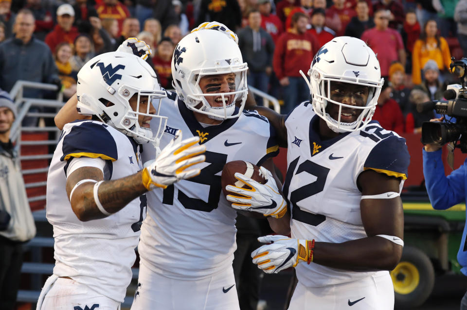 West Virginia wide receiver David Sills V, center, celebrates with teammates after catching an 18-yard touchdown pass during the first half of an NCAA college football game against Iowa State, Saturday, Oct. 13, 2018, in Ames, Iowa. (AP Photo/Charlie Neibergall)