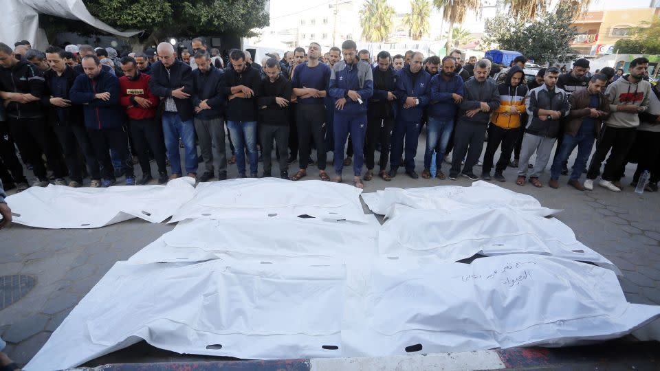 Palestinians perform Janazah, Islamic funeral prayers, at Al-Aqsa Martyrs Hospital, for those who were killed in Israeli attacks on the Nuseirat refugee camp, in Deir al-Balah, in central Gaza, on December 4. - Ashraf Amra/Anadolu/Getty Images