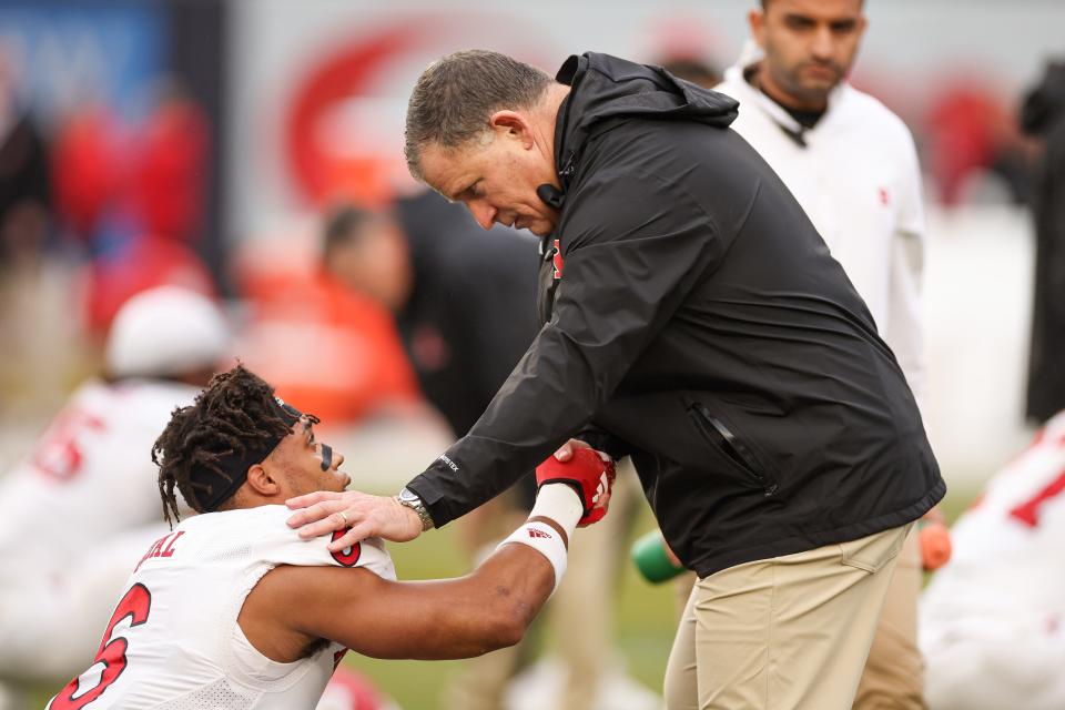 Dec 28, 2023; Bronx, NY, USA; Rutgers Scarlet Knights head coach Greg Schiano speaks with defensive back Shaquan Loyal (6) before the game against the Miami Hurricanes at Yankee Stadium. Mandatory Credit: Vincent Carchietta-USA TODAY Sports