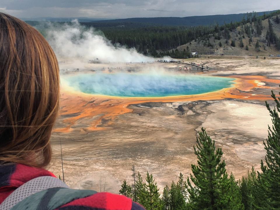 A woman looking out at Yosemite National Park.