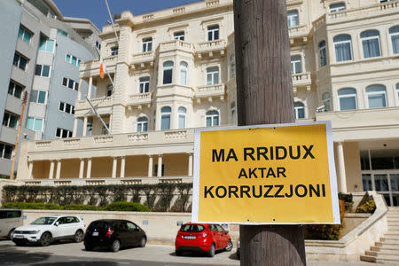 A placard reading: "We don't want any more corruption" is seen outside Whitehall Mansions, which houses the Maltese-registered Pilatus Bank, in Ta' Xbiex, Malta March 21, 2018. REUTERS/Darrin Zammit Lupi