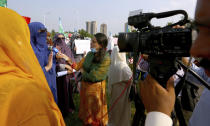 In this Friday, Sept. 11, 2020 photo, Wajiha Khanian, a female journalist from local tv channel Dawn News, interviews during protest, in Islamabad, Pakistan. Social media attacks against Pakistan's women journalists have been vile and vicious, some threatening rape, others even threatening death and the culprits are most often allied to the ruling party, even prompting the Committee to Protect Journalists to issue a statement on Friday condemning the relentless attacks. (AP Photo/Anjum Naveed)