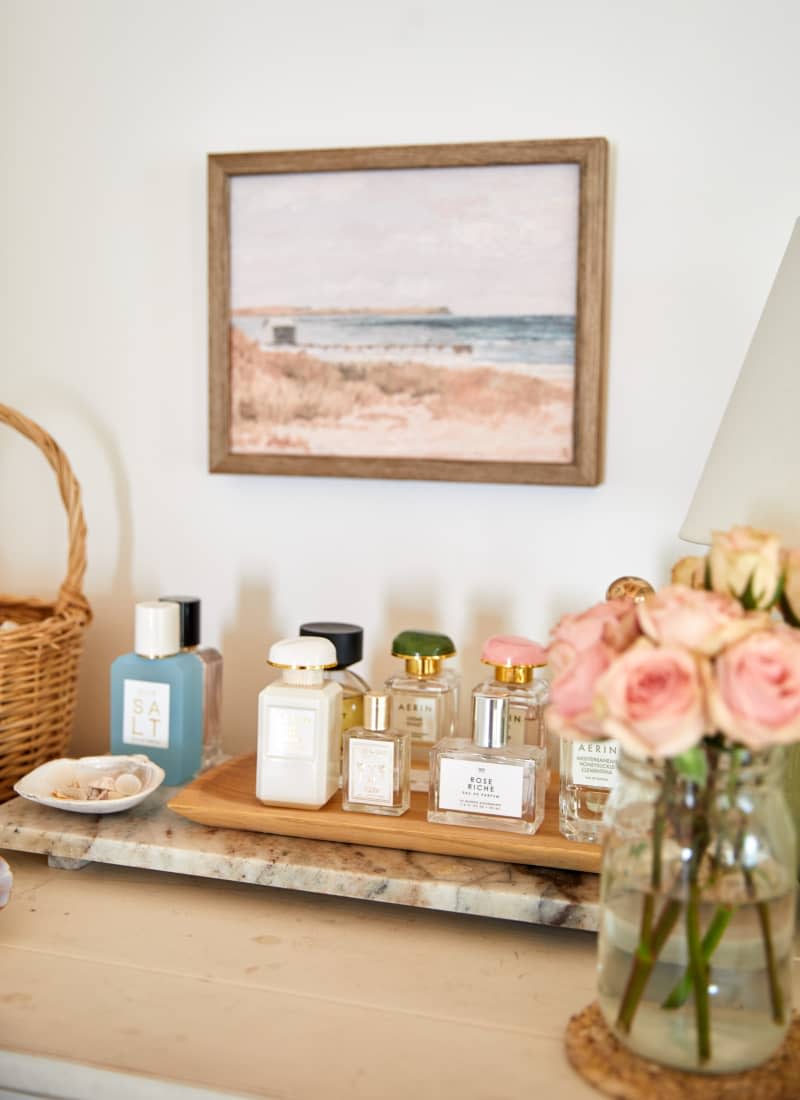 Frances sits on a shelf next to a vase of roses.