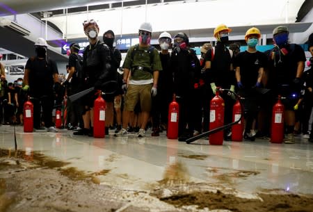 Protest at Yuen Long MTR station, the scene of an attack by suspected triad gang members a month ago, in Hong Kong