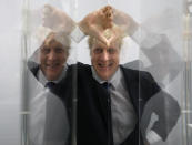 FILE - Boris Johnson, then Mayor of London in seen looking through perspex as models of the next two commissions that will appear on the fourth plinth in Trafalgar Square in London, Friday, Jan. 14, 2011. For Boris Johnson, facts have always been flexible. The British prime minister's career is littered with doctored quotes, tall tales, exaggerations and mistruths. When called out, he has generally offered an apologetic shrug or a guilty grin, and moved on. At least until now. Revelations that the prime minister and his staff partied while Britain was under coronavirus restrictions has provoked public outrage. (AP Photo/Kirsty Wigglesworth, File)