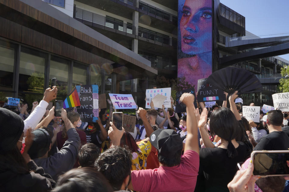 People protest outside the Netflix building on Vine Street in the Hollywood section of Los Angeles, Wednesday, Oct. 20, 2021. Critics and supporters of Dave Chappelle's Netflix special and its anti-transgender comments gathered outside the company's offices Wednesday, with "Trans Lives Matter" and "Free Speech is a Right" among their competing messages. (AP Photo/Damian Dovarganes)