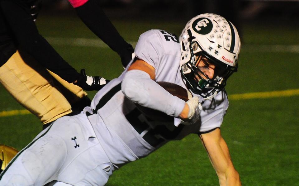 Central Catholic's Daniel Boron dives forward for extra yards against St. Thomas Aquinas, Friday, Oct. 20, 2023.